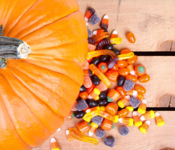 Pumpkin and halloween candy on a wooden crate