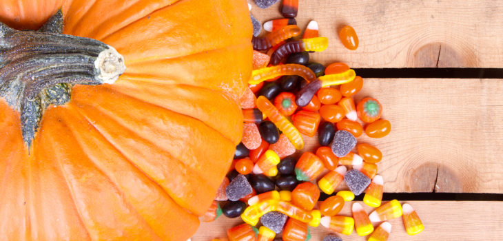 Pumpkin and halloween candy on a wooden crate